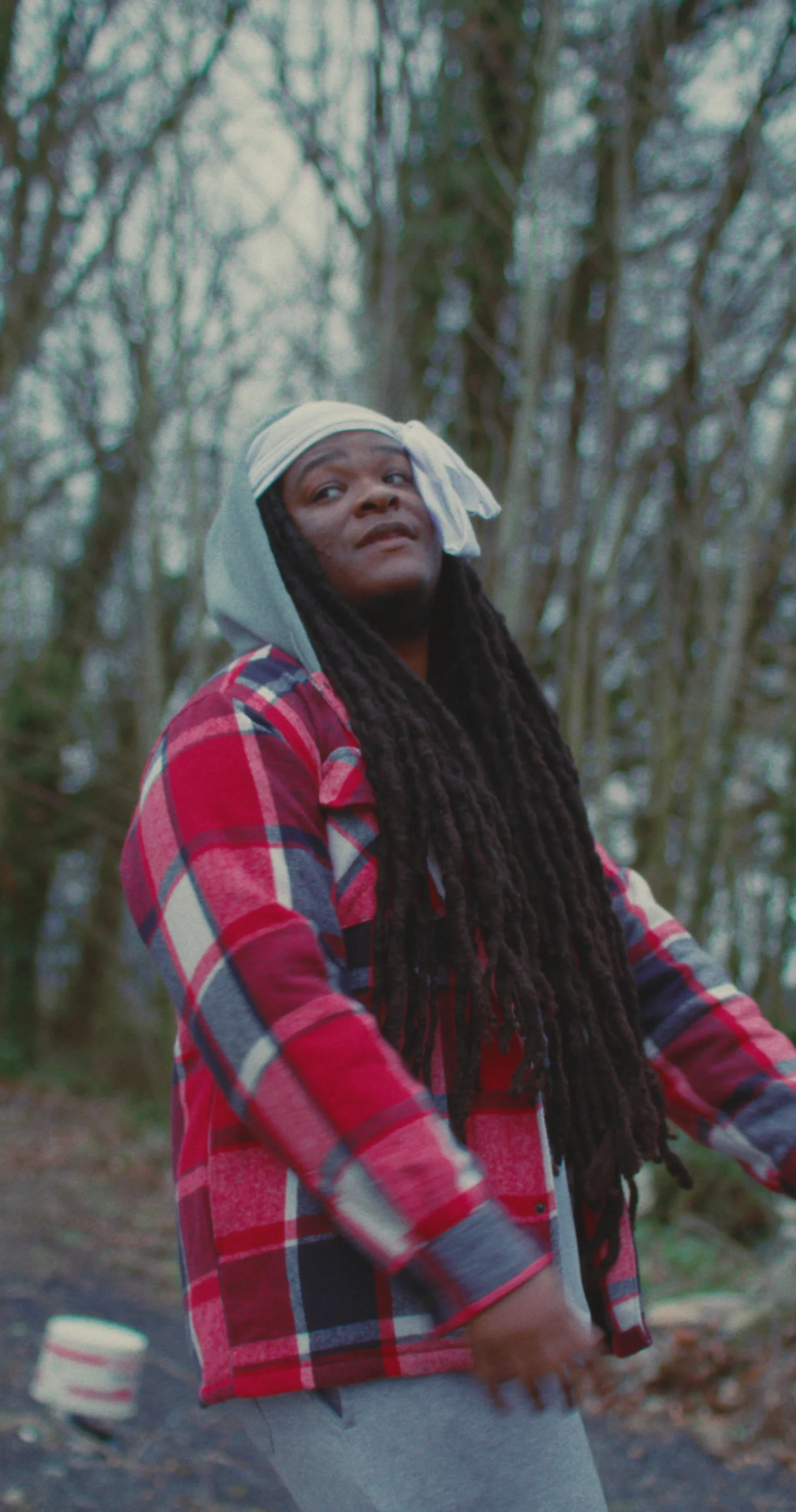 Malik Tijōn in a red flannel among winter trees